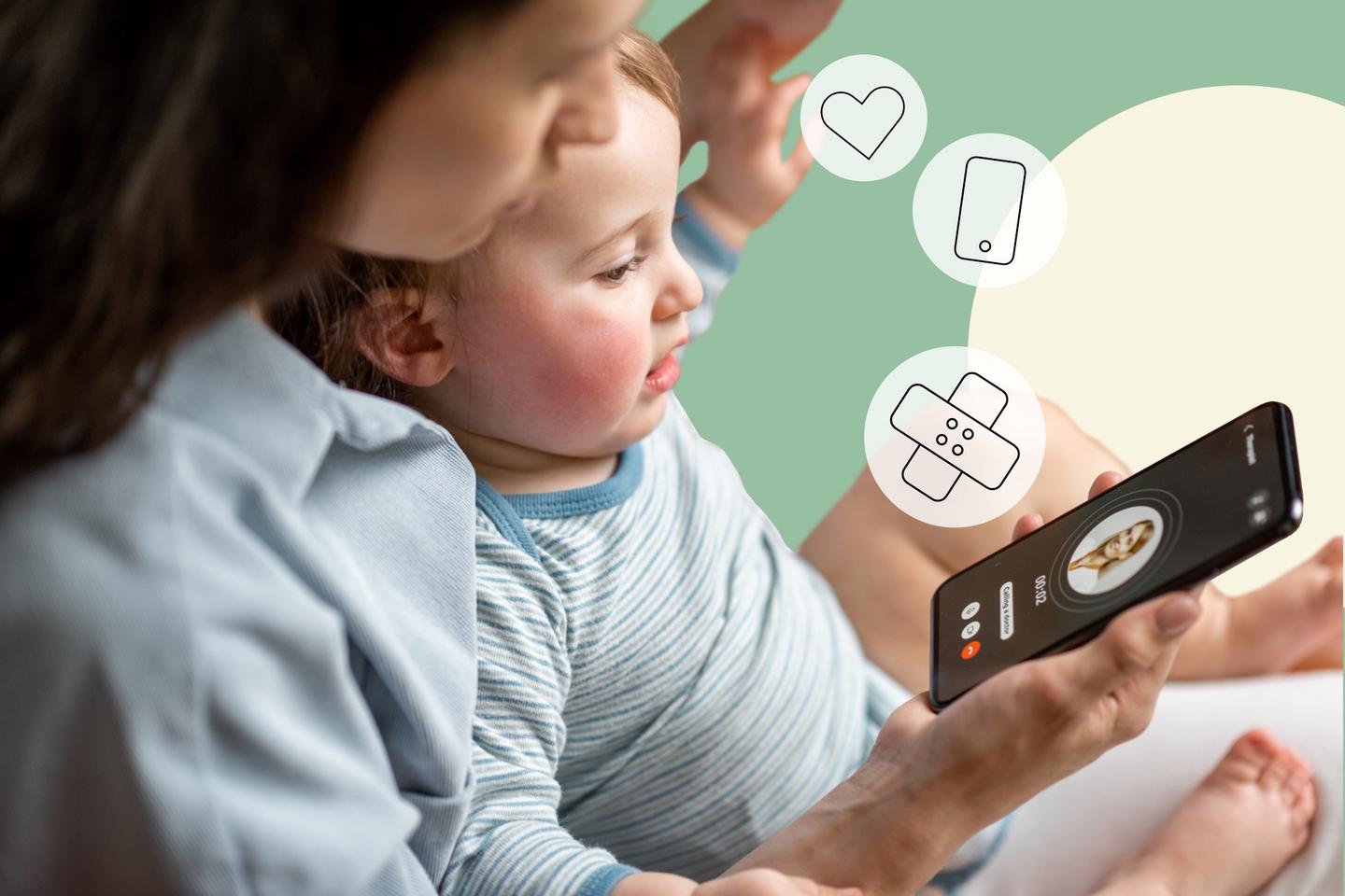 Woman with a baby on her lap holding a smartphone