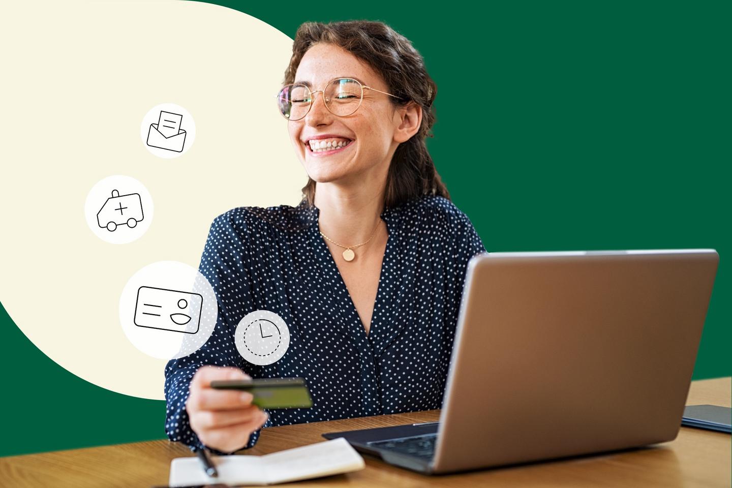 Woman sits at her laptop and holds an electronic health card in her hand